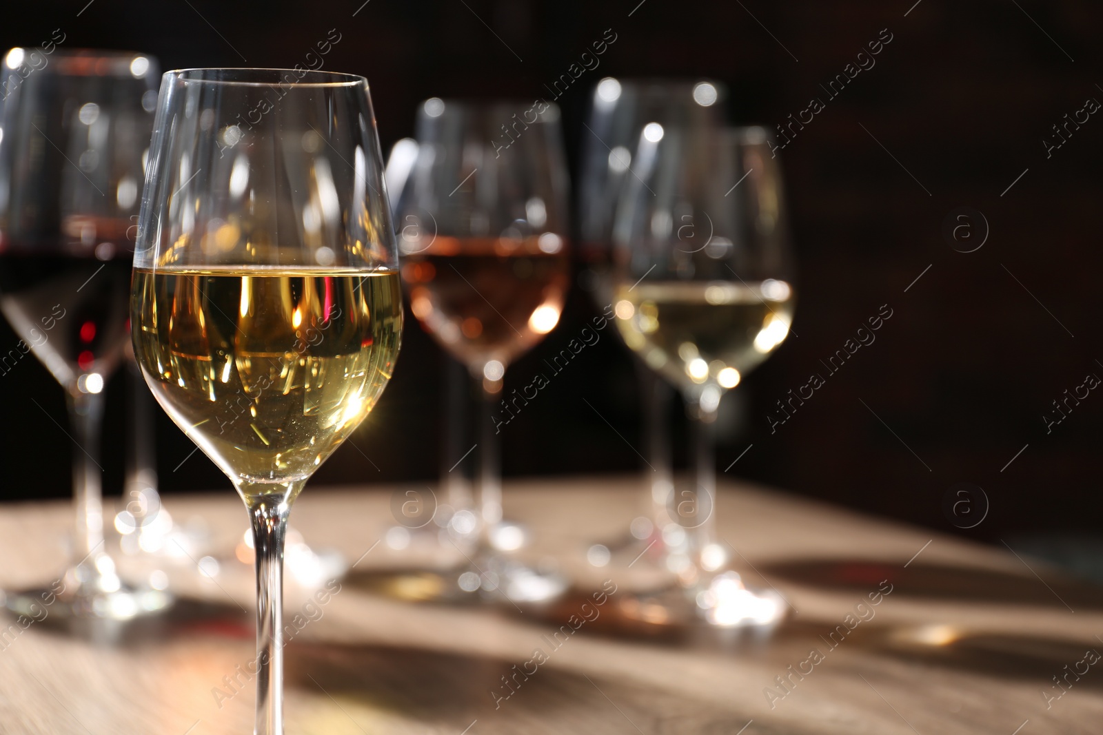 Photo of Tasty wine in glass on table, space for text