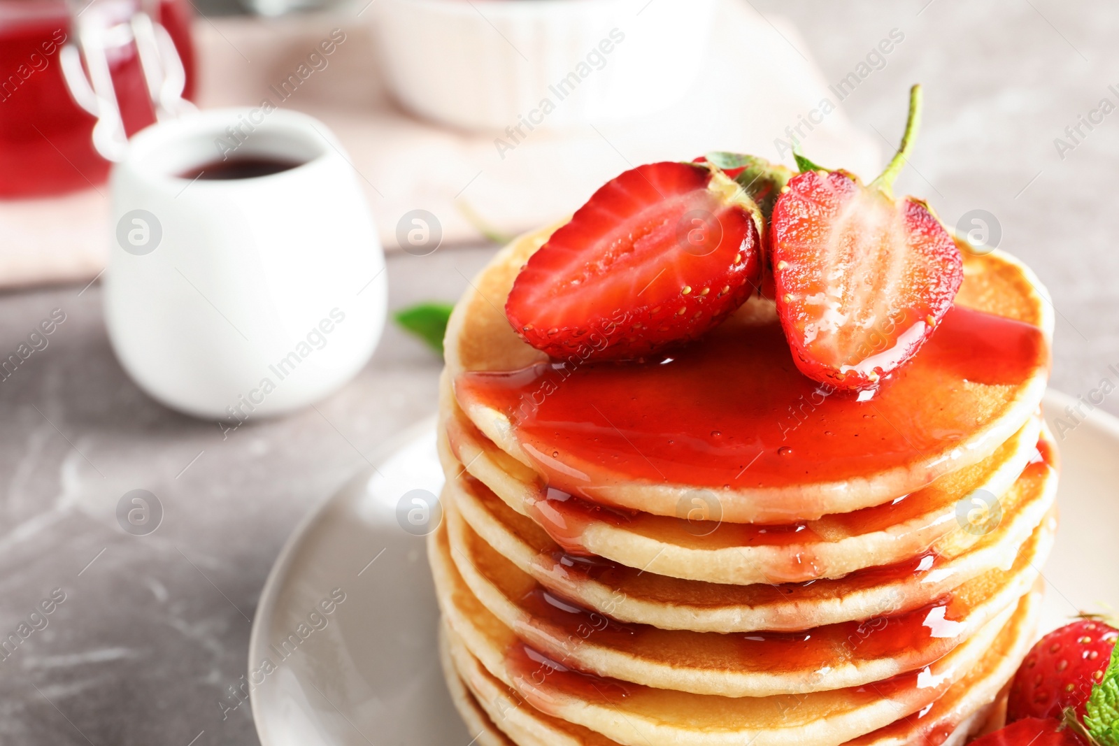 Photo of Plate with pancakes and berries on table, closeup