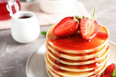 Plate with pancakes and berries on table, closeup