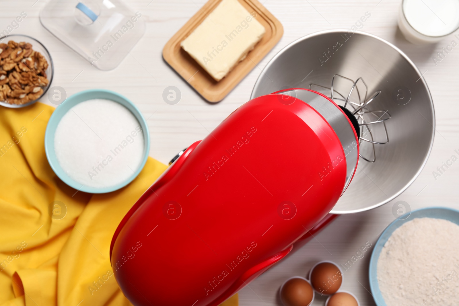 Photo of Modern red stand mixer and different ingredients on white wooden table, flat lay