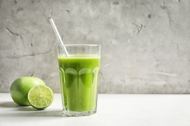 Photo of Glass with delicious detox juice and ingredients on table