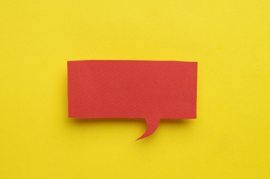 Paper speech bubble on yellow background, top view. Space for text