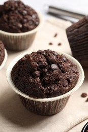 Tasty chocolate muffins on table, closeup view