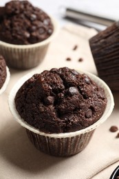 Photo of Tasty chocolate muffins on table, closeup view