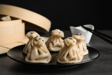 Photo of Plate with tasty baozi dumplings on table