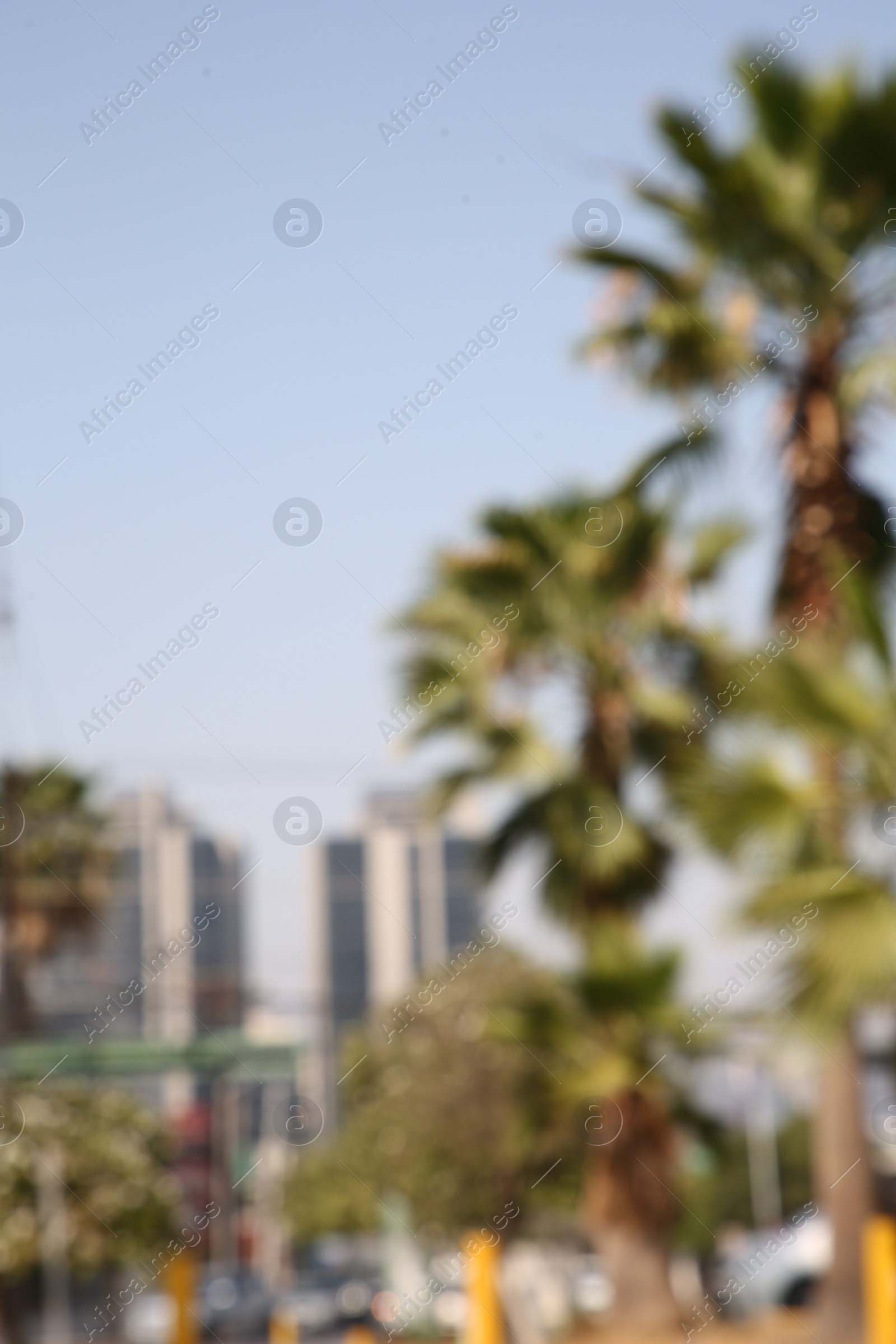 Photo of San Pedro Garza Garcia, Mexico – March 20, 2023: Blurred view of city with buildings and green palms