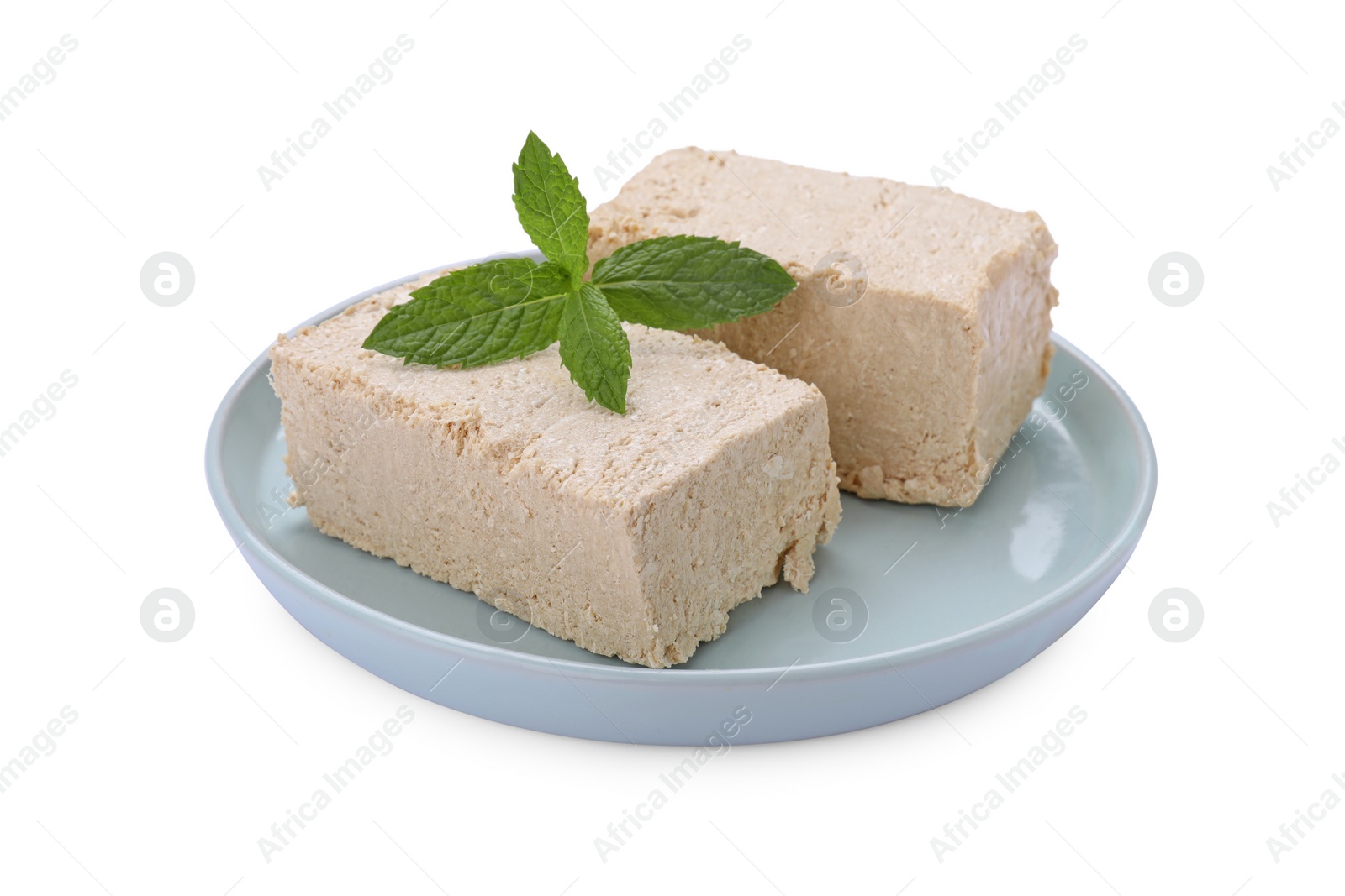 Photo of Plate with pieces of tasty halva and mint isolated on white