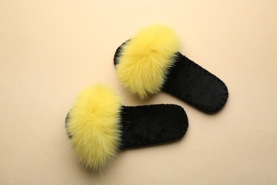 Photo of Pair of soft slippers on beige background, flat lay
