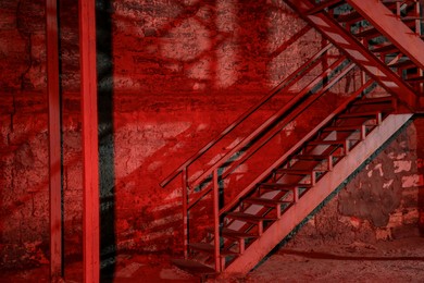 Old building with fire escape, toned in red