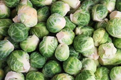 Photo of Fresh tasty Brussels sprouts as background, closeup