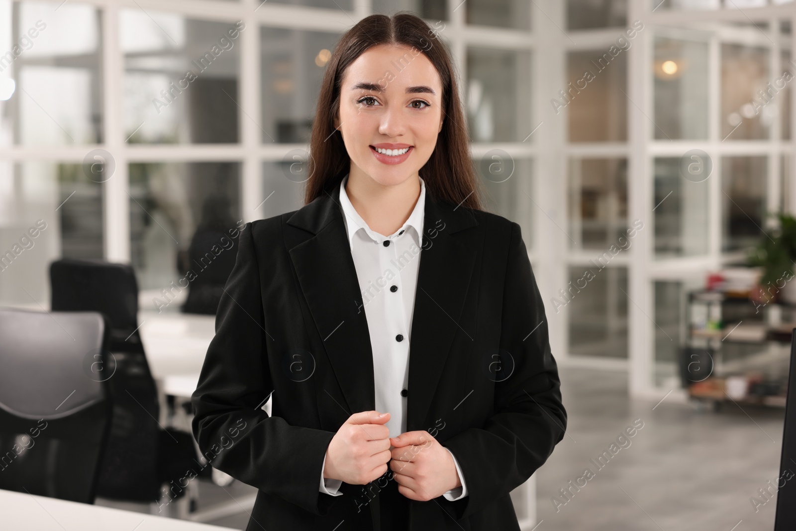 Photo of Happy female real estate agent in office