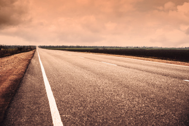 Image of Beautiful view of asphalt highway without transport. Orange tone