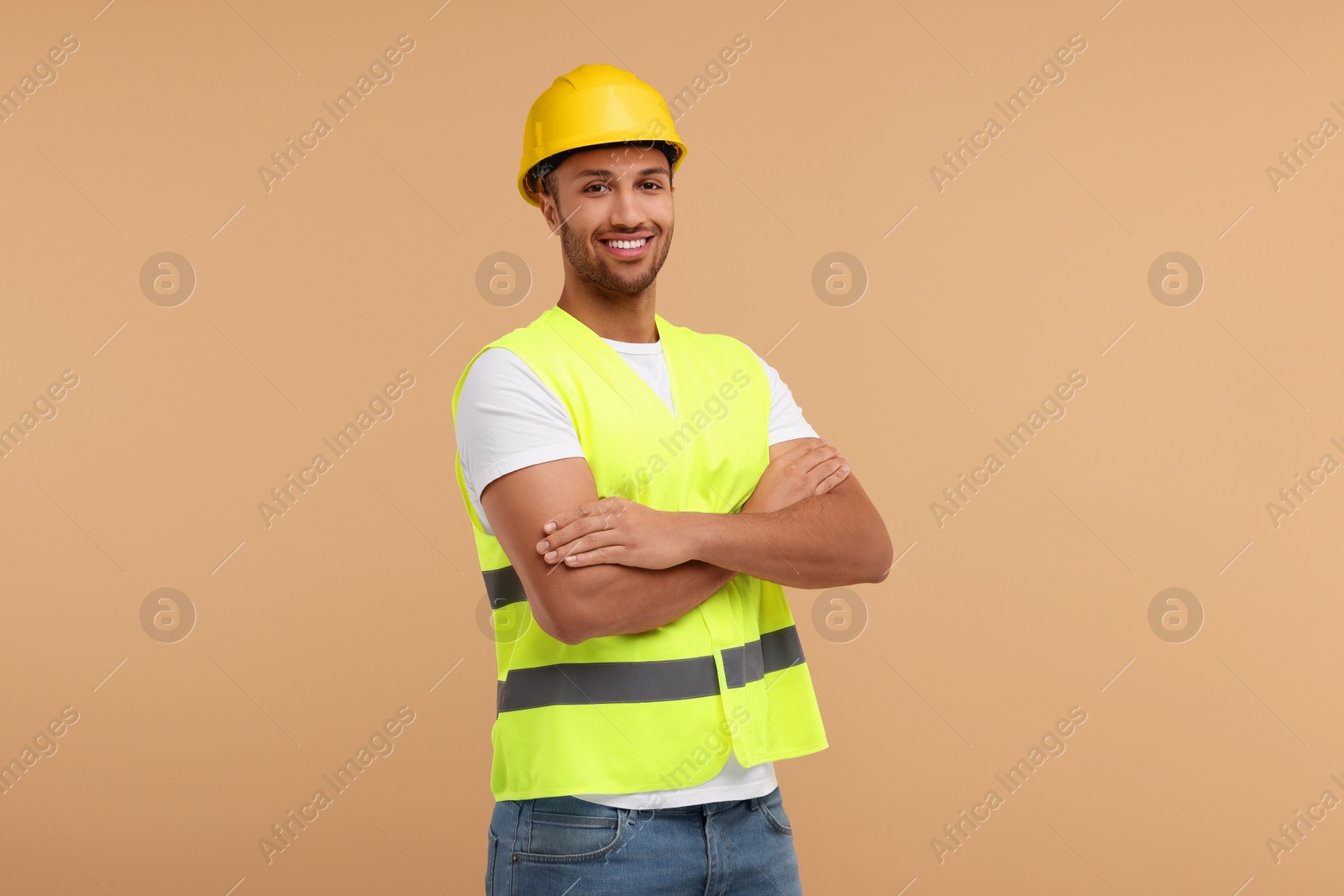 Photo of Engineer in hard hat on beige background