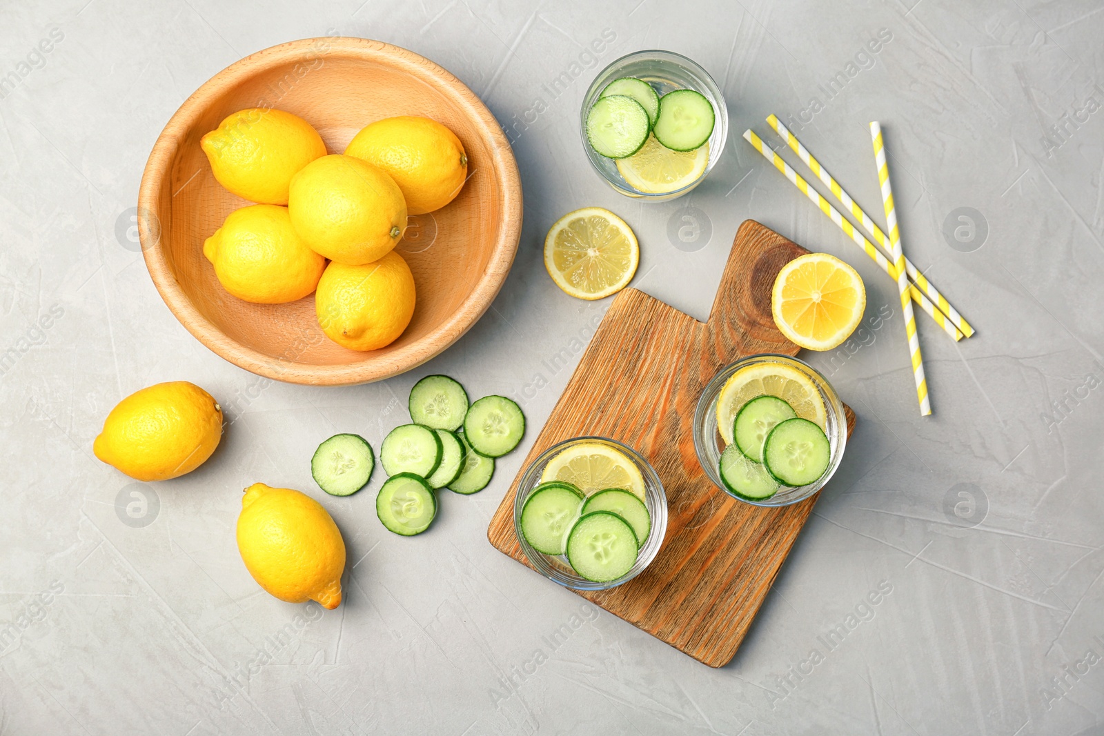 Photo of Flat lay composition with delicious natural lemonade on light background