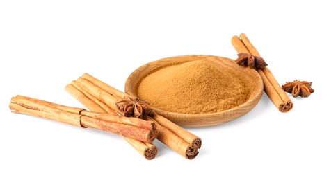 Dry aromatic cinnamon sticks, powder and anise stars isolated on white