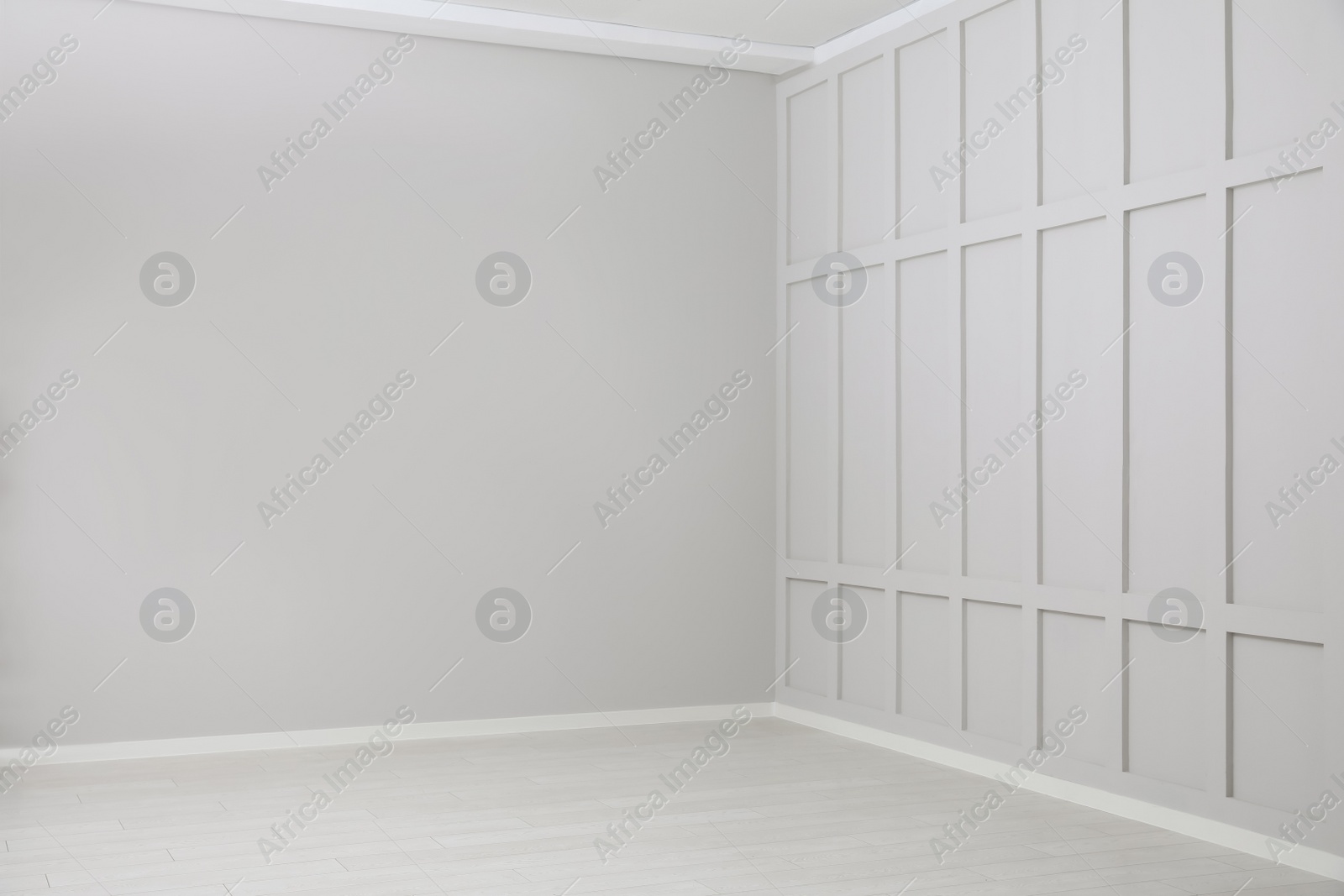 Photo of Empty spacious room with white wooden floor and walls