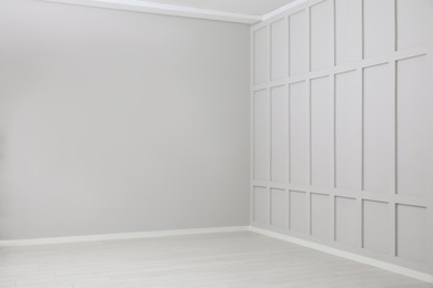 Photo of Empty spacious room with white wooden floor and walls
