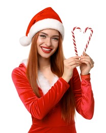 Photo of Young woman in red dress and Santa hat with candy canes on white background. Christmas celebration