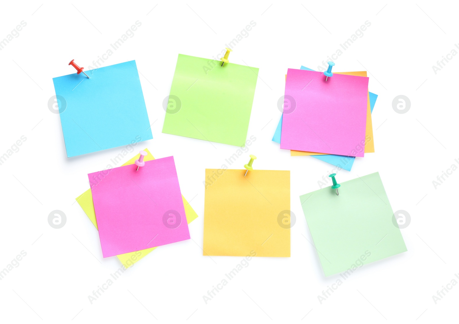 Photo of Blank colorful notes pinned on white background, top view. Space for text