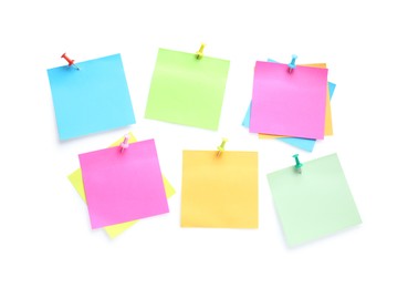 Blank colorful notes pinned on white background, top view. Space for text