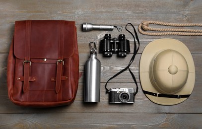 Photo of Flat lay composition with different safari accessories on wooden background