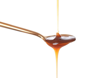 Photo of Pouring salted caramel into spoon isolated on white
