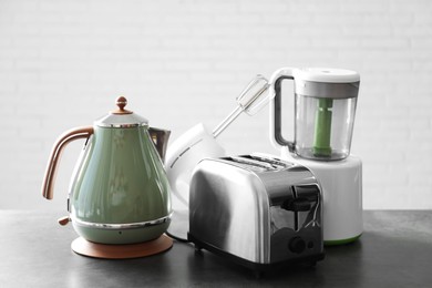 Photo of Set of modern home appliances on grey table