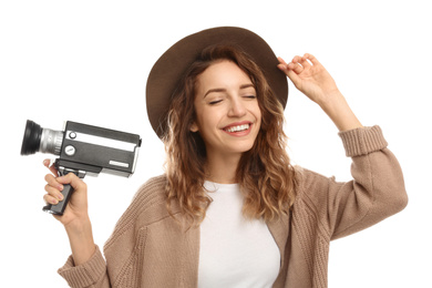 Beautiful young woman with vintage video camera on white background
