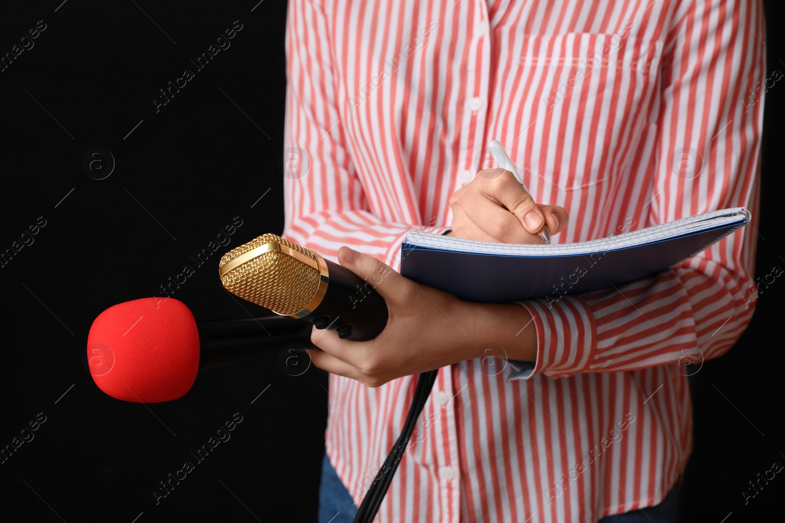 Photo of Journalist with microphones and notebook on black background, closeup