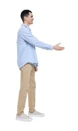 Photo of Young man in light blue shirt and beige pants on white background