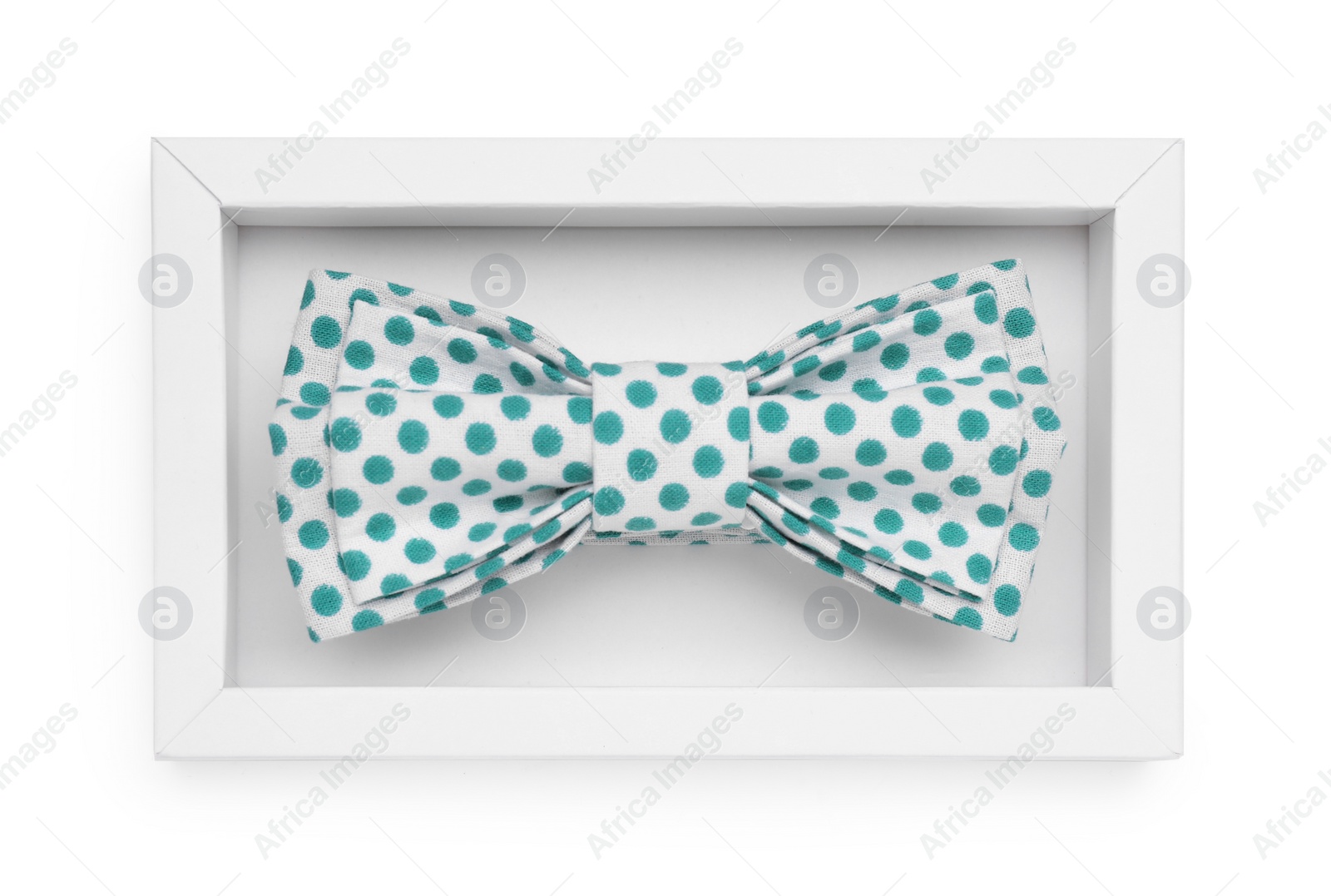 Photo of Stylish bow tie with green polka dot pattern on white background, top view