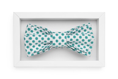 Stylish bow tie with green polka dot pattern on white background, top view