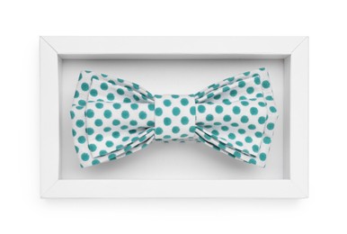 Photo of Stylish bow tie with green polka dot pattern on white background, top view