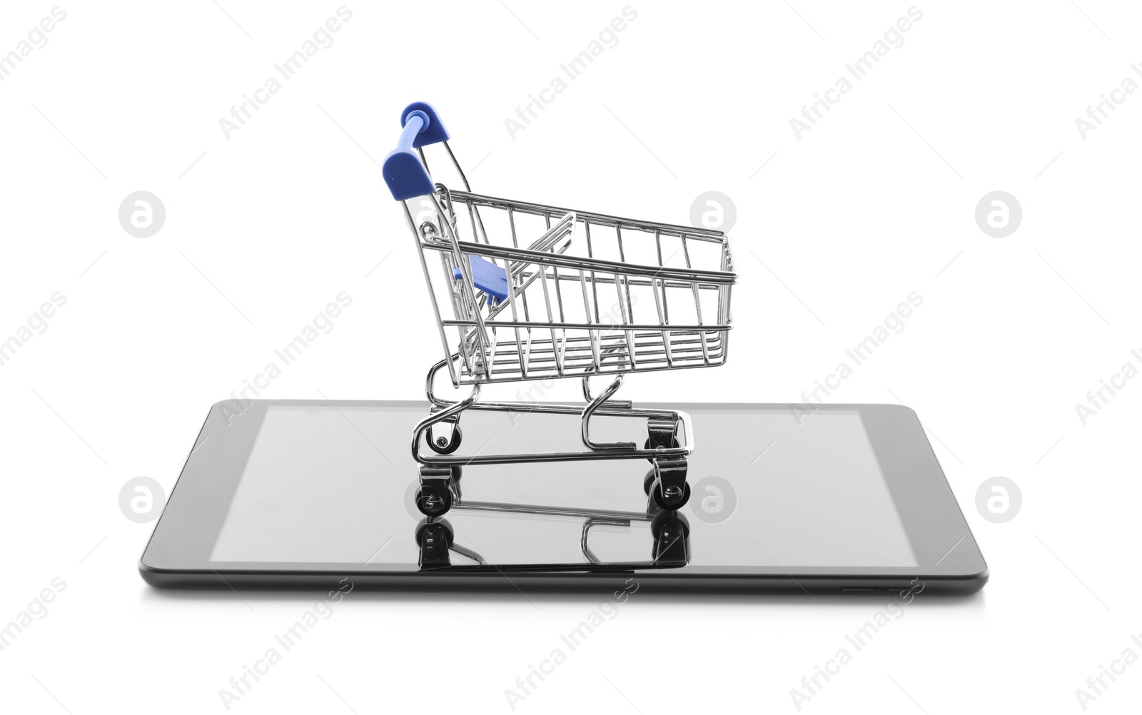 Photo of Internet shopping. Small cart and modern tablet on white background