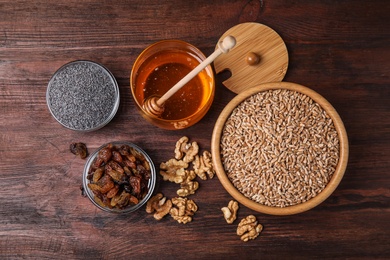 Ingredients for traditional kutia on wooden table, flat lay