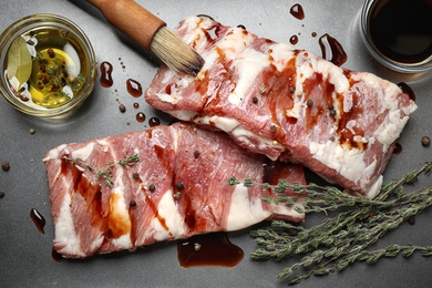 Fresh raw ribs on grey surface, flat lay