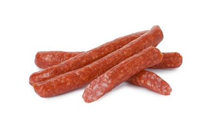 Photo of Thin dry smoked sausages isolated on white