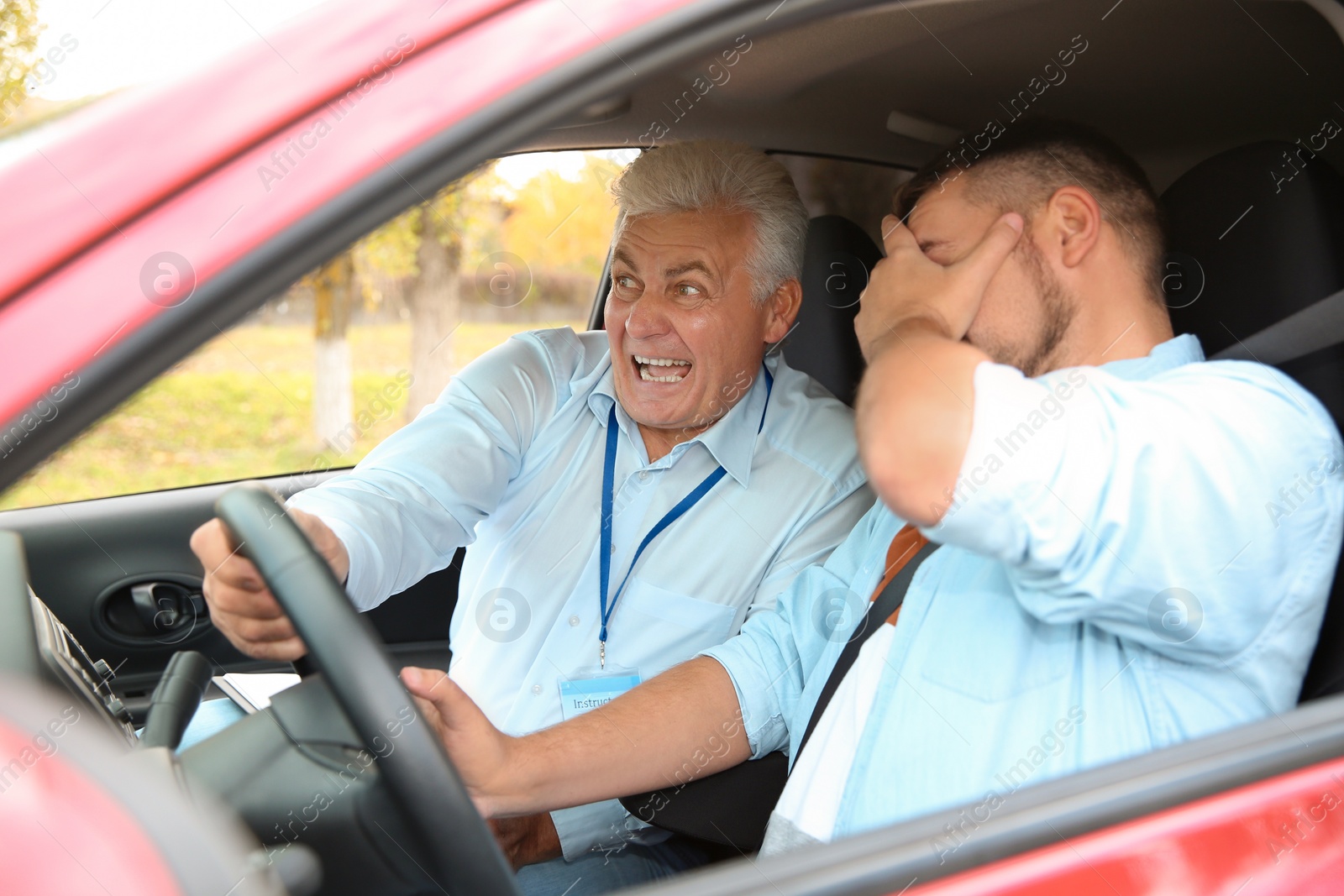 Photo of Man and instructor in car. Fail driving license exam