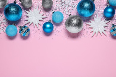 Photo of Shiny Christmas balls, decorative snowflakes and glitter on pink background, flat lay. Space for text