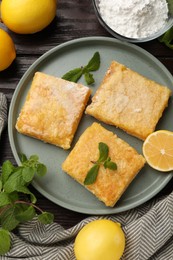 Tasty lemon bars served on wooden table, flat lay