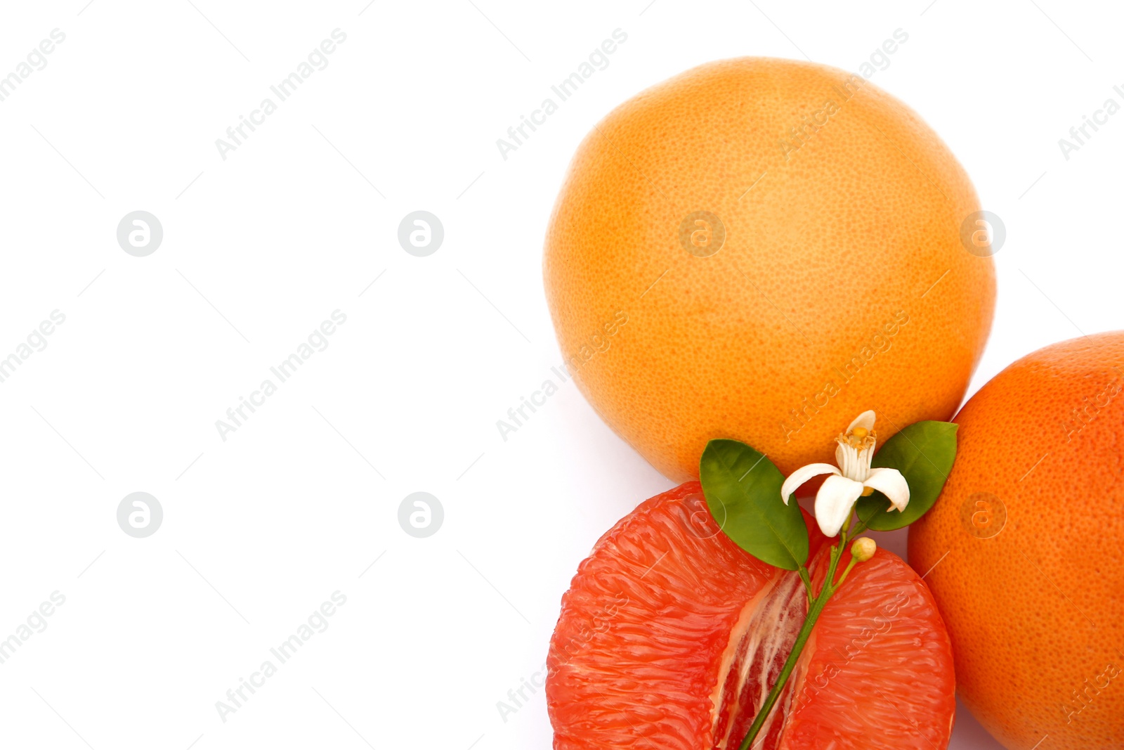 Photo of Fresh grapefruits and green leaves on white background, top view. Space for text