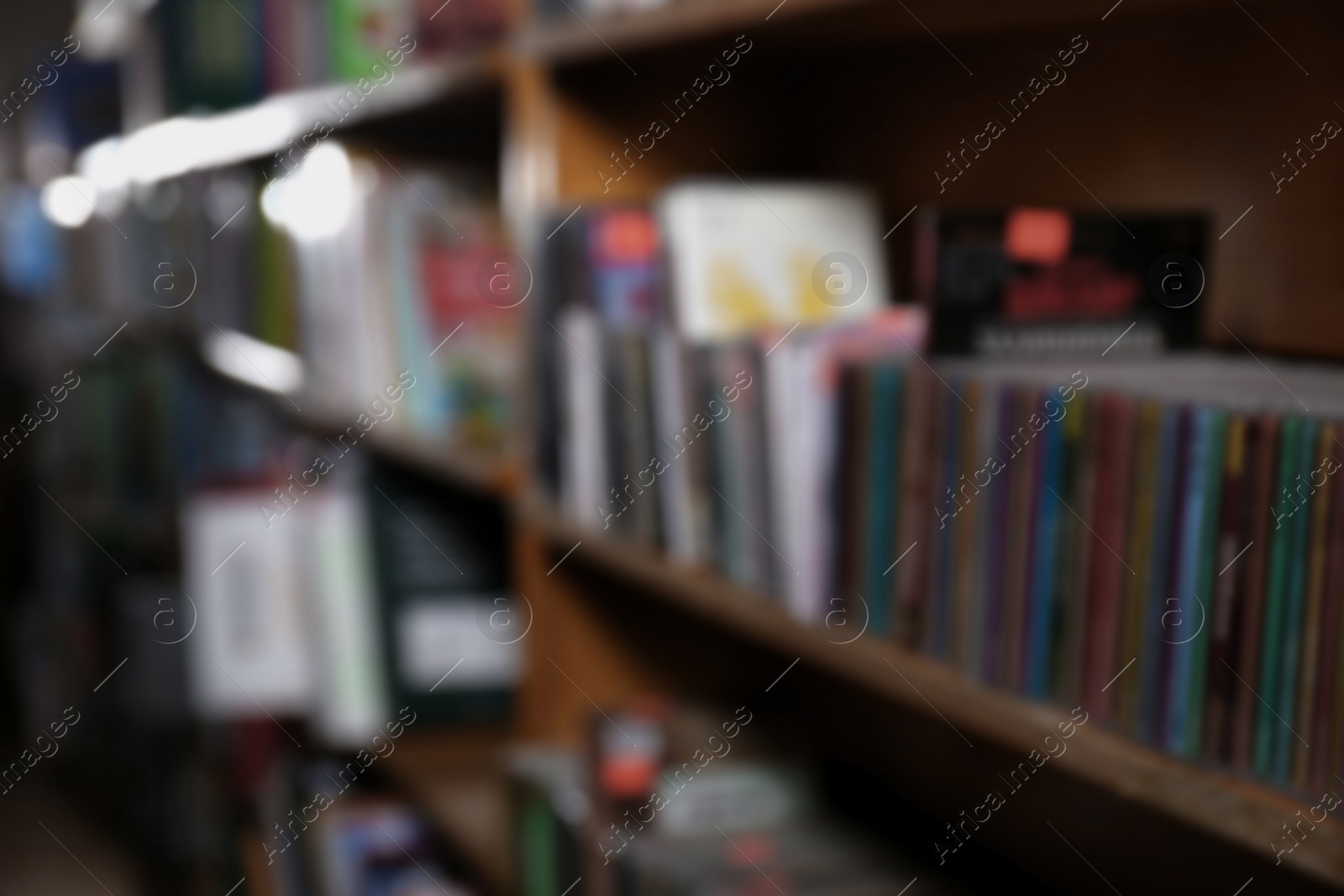 Photo of Blurred view of different books on shelves in library