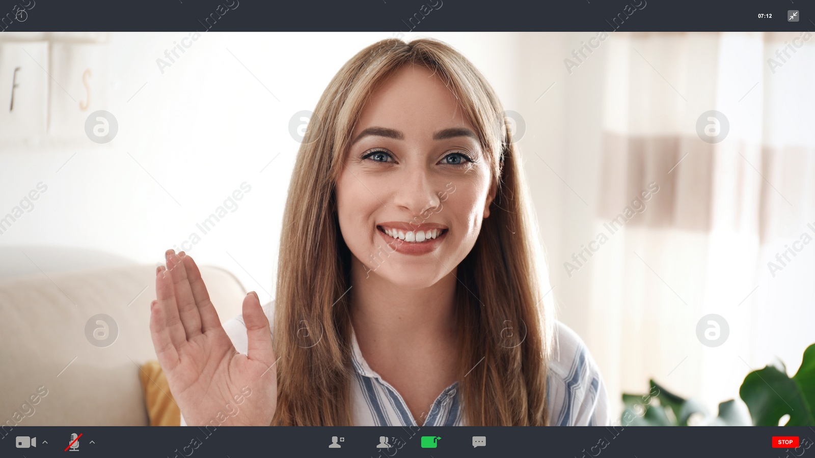 Image of Woman communicating with coworkers from home using video chat, view through camera