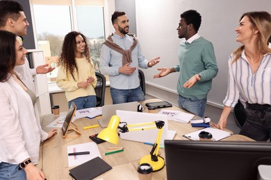 Photo of Team of employees working together in office. Startup project