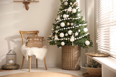 Beautiful decorated Christmas tree in festive room interior