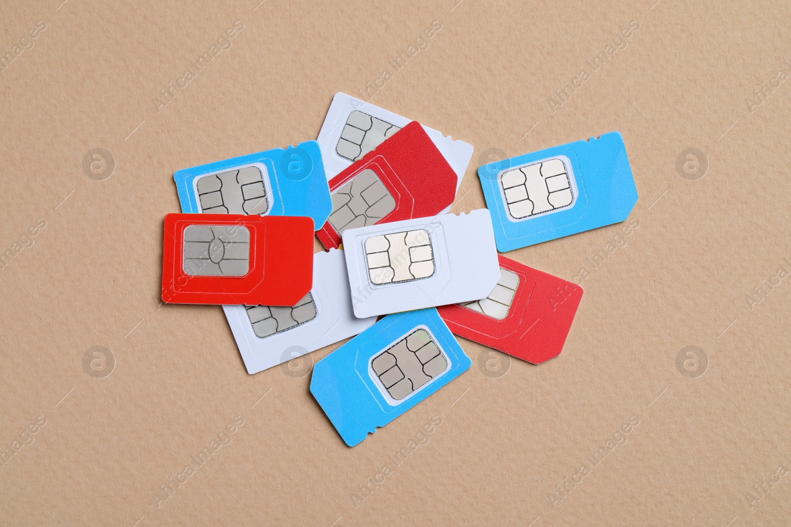 Photo of Pile of different SIM cards on beige background, flat lay