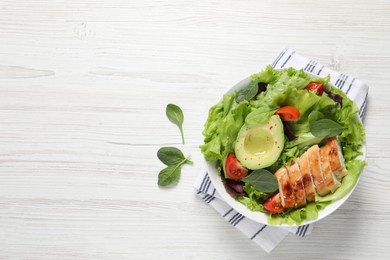 Delicious salad with chicken, cherry tomato and avocado on white wooden table, top view. Space for text