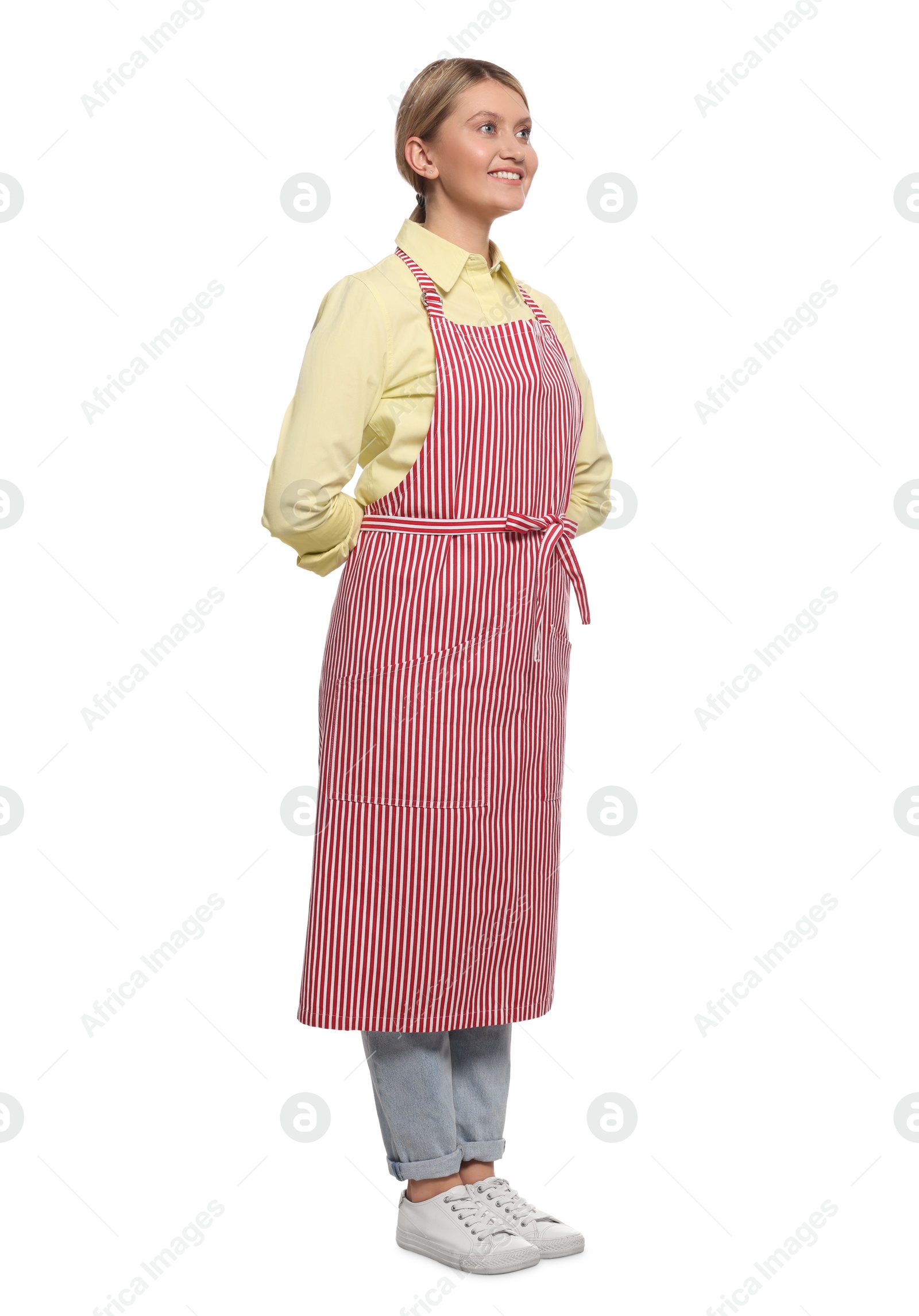 Photo of Beautiful young woman in clean striped apron on white background