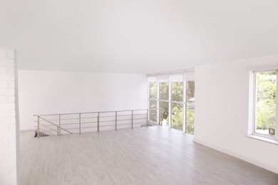 Photo of Empty room with windows and laminated floor