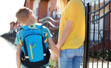 Young woman taking her child to school